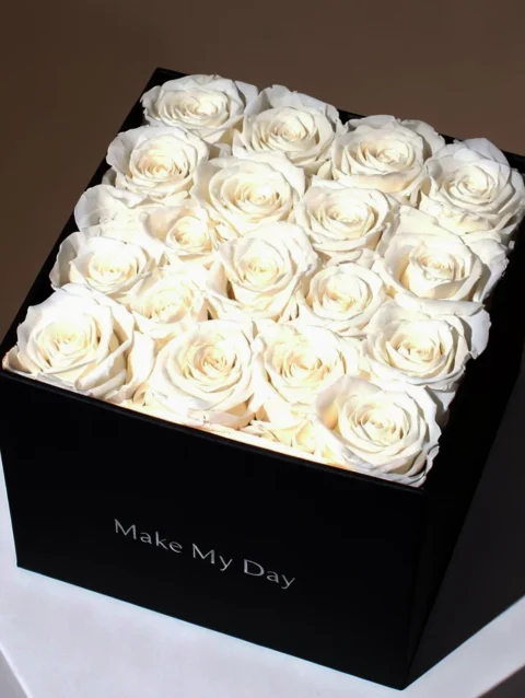 Elegant white rose arrangement in black square box